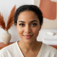 Close-up portrait of a smiling woman with perfectly lifted and curled eyelashes, looking happy and confident.